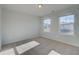 Cozy bedroom with neutral carpet, two windows, and ample natural light at 124 Dalston Cv, Stockbridge, GA 30281
