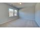 A cozy bedroom featuring neutral carpet, two windows that provides plenty of natural light at 124 Dalston Cv, Stockbridge, GA 30281