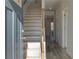 Inviting entryway featuring hardwood floors, a staircase with wood banister, and light gray walls at 124 Dalston Cv, Stockbridge, GA 30281