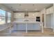 Contemporary kitchen boasts white cabinets, stainless steel appliances, and a large island at 124 Dalston Cv, Stockbridge, GA 30281