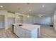 Spacious kitchen with a large island, stainless steel sink, and view of the living area at 124 Dalston Cv, Stockbridge, GA 30281