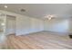 Spacious living room with light wood-look flooring, ceiling fan, and ample natural light at 124 Dalston Cv, Stockbridge, GA 30281