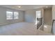 Upstairs loft featuring neutral carpet, natural light, and staircase with wooden railing at 124 Dalston Cv, Stockbridge, GA 30281