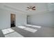 Spacious main bedroom features trey ceiling, fan, neutral carpet, and access to en suite bathroom at 124 Dalston Cv, Stockbridge, GA 30281