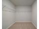 Walk-in closet with wall-mounted wire shelving and carpeted floor at 124 Dalston Cv, Stockbridge, GA 30281