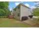 Exterior of home with deck, lush green lawn, and driveway at 1558 Ember Oaks Cir, Powder Springs, GA 30127