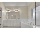 Bathroom features double sinks, a large mirror, and a separate tub and shower at 1558 Ember Oaks Cir, Powder Springs, GA 30127