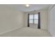 Neutral bedroom featuring a window with coverings, plush carpeting, and closet at 1558 Ember Oaks Cir, Powder Springs, GA 30127