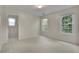 Carpeted bedroom featuring a pass-through, two windows and a ceiling light at 1558 Ember Oaks Cir, Powder Springs, GA 30127