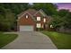 Beautiful two-story brick home with an attached two-car garage and a well-maintained yard at 1558 Ember Oaks Cir, Powder Springs, GA 30127