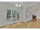 Bright living room with hardwood floors, a fireplace, and large windows offering views of the backyard at 1558 Ember Oaks Cir, Powder Springs, GA 30127