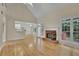 Spacious living room with hardwood floors, a vaulted ceiling, fireplace and large windows for natural light at 1558 Ember Oaks Cir, Powder Springs, GA 30127