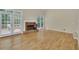 Bright and airy living room featuring hardwood floors, a fireplace, and access to an outdoor deck at 1558 Ember Oaks Cir, Powder Springs, GA 30127