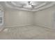 Spacious main bedroom featuring a tray ceiling and plush carpet at 1558 Ember Oaks Cir, Powder Springs, GA 30127