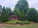 Tamarack Farms neighborhood entrance sign with lush greenery at 1558 Ember Oaks Cir, Powder Springs, GA 30127