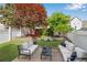 A charming outdoor lounge space with beautiful, professionally landscaped backyard at 753 Cambron Commons Trce, Suwanee, GA 30024