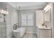 Bright bathroom with a soaking tub, marble countertop vanity, and a glass-enclosed shower at 753 Cambron Commons Trce, Suwanee, GA 30024