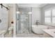 Modern bathroom featuring a glass shower, soaking tub, and stylish fixtures and barn door at 753 Cambron Commons Trce, Suwanee, GA 30024