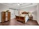 Spacious bedroom with tray ceilings, hardwood floors, and access to the bathroom at 753 Cambron Commons Trce, Suwanee, GA 30024