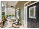 Cozy front porch with rocking chair and swing, offering a relaxing outdoor space by the front door at 753 Cambron Commons Trce, Suwanee, GA 30024