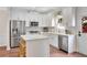 Bright kitchen featuring stainless steel appliances, a kitchen island, and white cabinetry at 753 Cambron Commons Trce, Suwanee, GA 30024