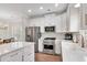 Well-lit kitchen with stainless steel appliances, white countertops, and modern fixtures at 753 Cambron Commons Trce, Suwanee, GA 30024
