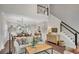 Spacious living room with a cozy seating area, dining space, and stairs at 753 Cambron Commons Trce, Suwanee, GA 30024