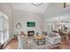Bright living room featuring a fireplace, hardwood floors, and an open layout to the dining area at 753 Cambron Commons Trce, Suwanee, GA 30024