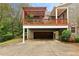 Back exterior of a home with an upper deck and a covered garage space, providing outdoor enjoyment and parking at 963 Manor Parc Dr, Decatur, GA 30033