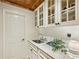 Elegant bar area with granite counters, white cabinets, and a stylish sink at 963 Manor Parc Dr, Decatur, GA 30033
