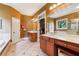 Bright bathroom featuring double vanities, a soaking tub, glass shower and a large mirror reflecting a view of the room at 963 Manor Parc Dr, Decatur, GA 30033