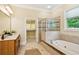Luxury bathroom featuring a soaking tub, glass shower, and double vanity at 963 Manor Parc Dr, Decatur, GA 30033