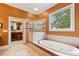 Lovely bathroom offering a soaking tub, separate shower, and access to a spacious walk-in closet with ample storage at 963 Manor Parc Dr, Decatur, GA 30033