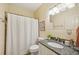 Clean bathroom featuring granite counters, shower curtain, and a well-lit mirror at 963 Manor Parc Dr, Decatur, GA 30033