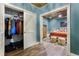 Bedroom view showcases a walk-in closet and an adjacent cozy bedroom with wooden bed frame at 963 Manor Parc Dr, Decatur, GA 30033