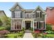 Stunning two-story home with red framed windows, stone accents, and a well-manicured front yard at 963 Manor Parc Dr, Decatur, GA 30033