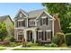 Beautifully landscaped two-story home with stone accents, manicured lawn, and elegant curb appeal at 963 Manor Parc Dr, Decatur, GA 30033