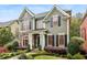 Charming two-story home with manicured lawn, stone accents, and inviting architectural details at 963 Manor Parc Dr, Decatur, GA 30033