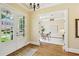 Grand foyer with view to study, features hardwood floors and glass paned doors with view of landscaped front yard at 963 Manor Parc Dr, Decatur, GA 30033