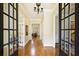 Inviting foyer with hardwood floors, chandelier lighting, and open access to other rooms in the home at 963 Manor Parc Dr, Decatur, GA 30033