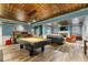 Open concept game room with pool table that flows into a cozy living area with fireplace at 963 Manor Parc Dr, Decatur, GA 30033