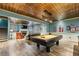Spacious game room includes a billiards table, elegant ceiling, fireplace, and comfortable seating area for entertainment at 963 Manor Parc Dr, Decatur, GA 30033