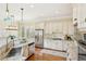 Modern kitchen with stainless steel appliances, granite countertops, white cabinets, and pendant lighting at 963 Manor Parc Dr, Decatur, GA 30033