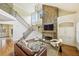 Open-concept living room boasts vaulted ceilings, stone fireplace, and hardwood floors at 963 Manor Parc Dr, Decatur, GA 30033