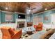 Stylish living room boasts an elegant ceiling, cozy fireplace, comfortable seating, and a piano in the background at 963 Manor Parc Dr, Decatur, GA 30033