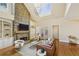 Spacious living room featuring a stone fireplace, built-in shelving, and abundant natural light at 963 Manor Parc Dr, Decatur, GA 30033