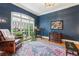 Cozy living room with blue walls, large window and traditional decor at 963 Manor Parc Dr, Decatur, GA 30033