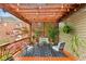 Relaxing patio with string lights, a comfortable seating area, decorative plants, and a pergola for shade and ambiance at 963 Manor Parc Dr, Decatur, GA 30033