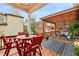 Inviting outdoor patio area with a wooden pergola, stylish seating, and a dining set for outdoor entertaining at 963 Manor Parc Dr, Decatur, GA 30033