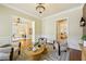 Elegant sitting area with wainscoting, brick accent wall, modern lighting, and neutral decor at 963 Manor Parc Dr, Decatur, GA 30033